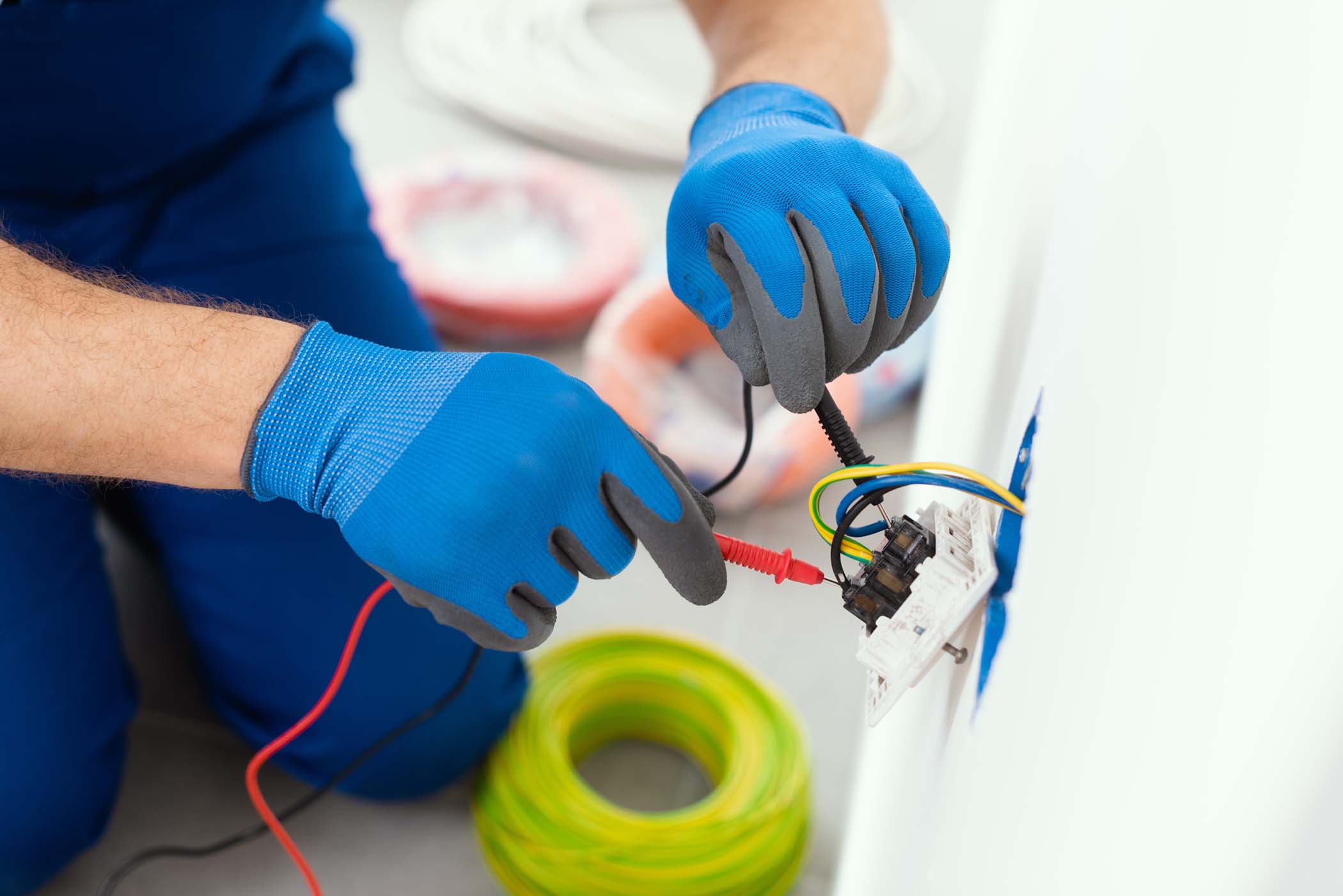 professional electrician testing outlet